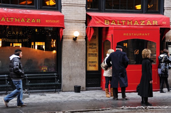 Exterior of New York's Balthazar Restaurant, displaying a red awning with gold lettering